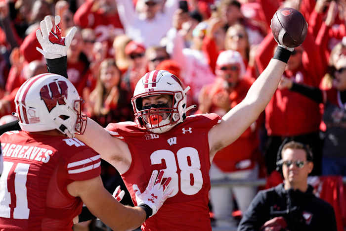 Oct 7, 2023; Madison, Wisconsin, USA; Wisconsin Badgers tight end Tucker Ashcraft (38) celebrates with wide receiver Skyler Bell (11) after scoring a touchdown during the fourth quarter against the Rutgers Scarlet Knights at Camp Randall Stadium. Mandatory Credit: Jeff Hanisch-USA TODAY Sports